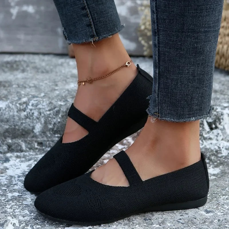 Black comfortable slip-on shoes with strap detail worn with dark frayed jeans