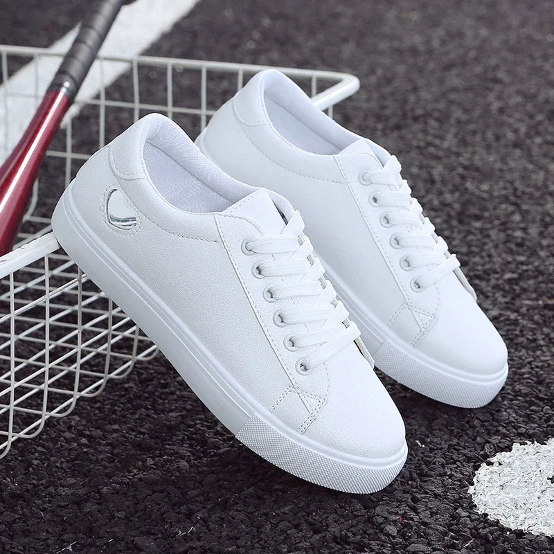 White flower design running shoes for ladies by The Lady's Haven Boutique on black pavement