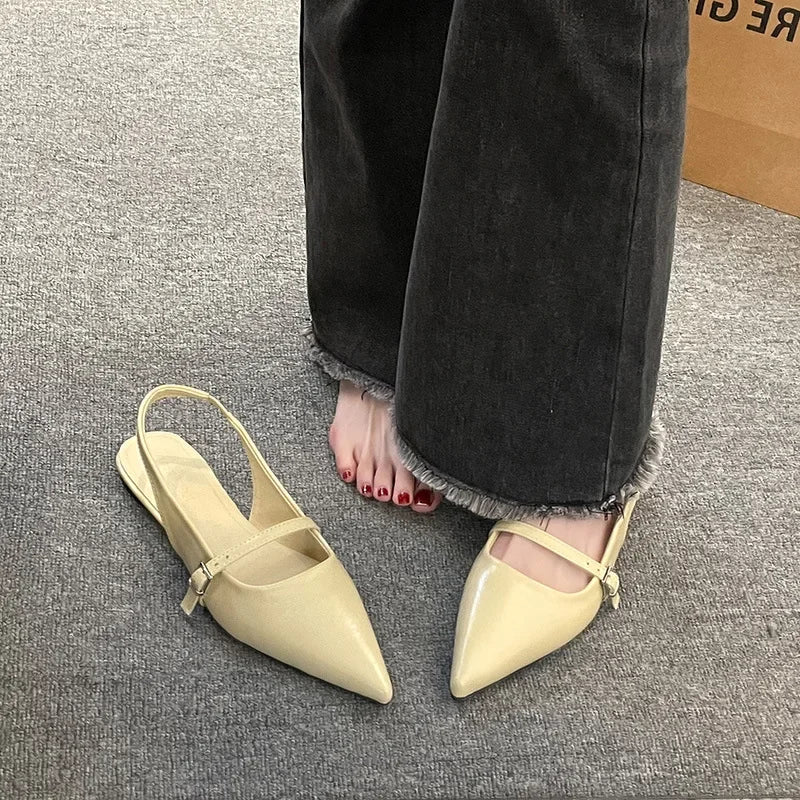 French chic diamond buckle flats in beige with pointed toes and slingback design worn with black frayed jeans