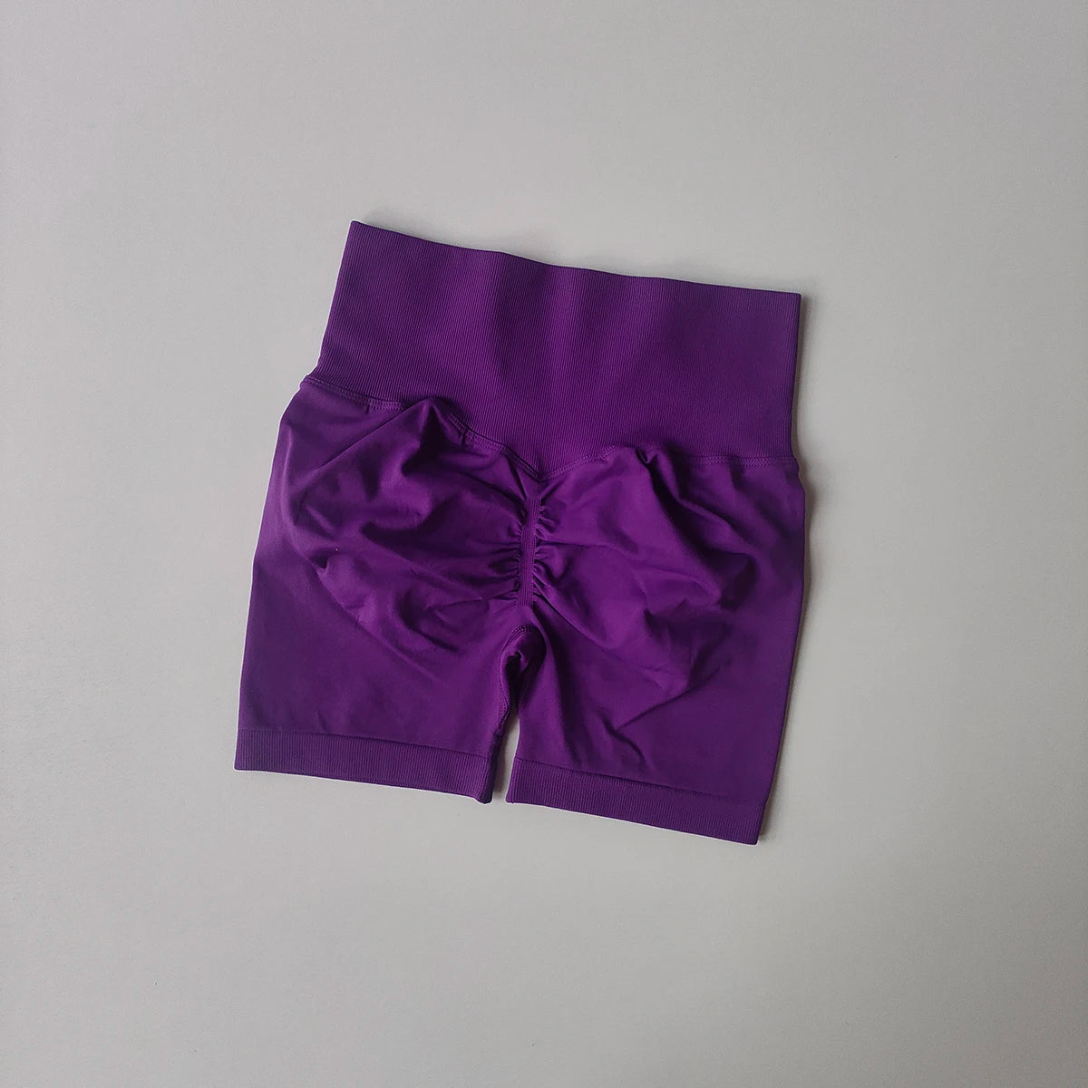Purple high-waist yoga shorts women with stylish ruching detail for comfort and flexibility