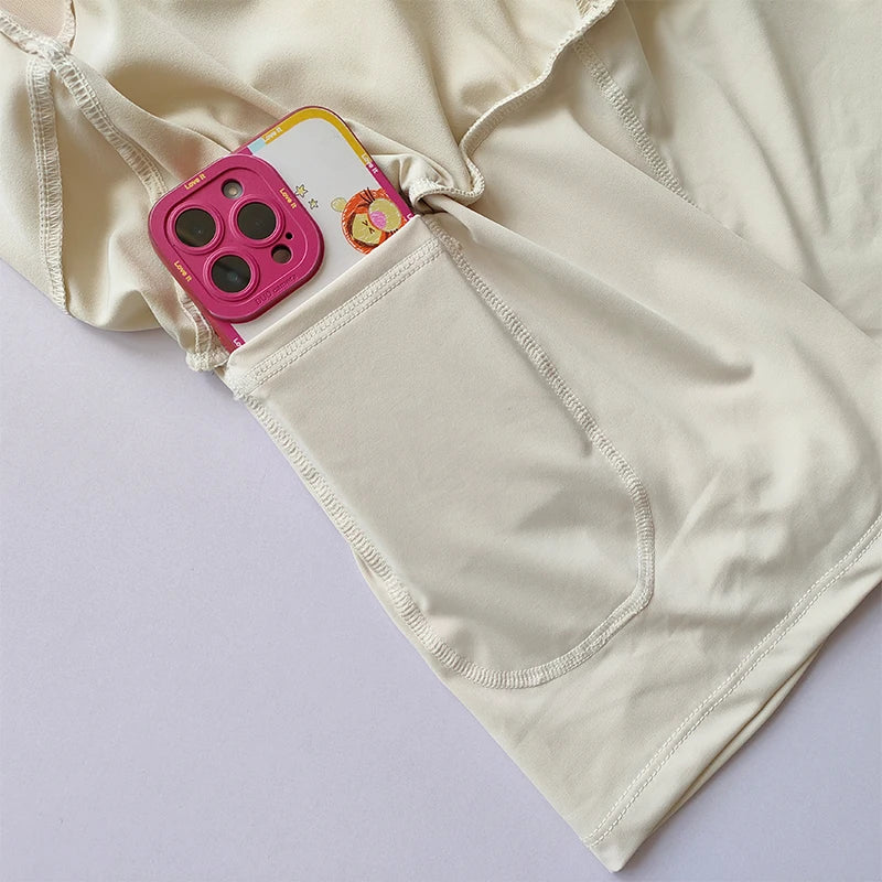 Beige high-waisted sports shorts women with side pocket for phone convenience