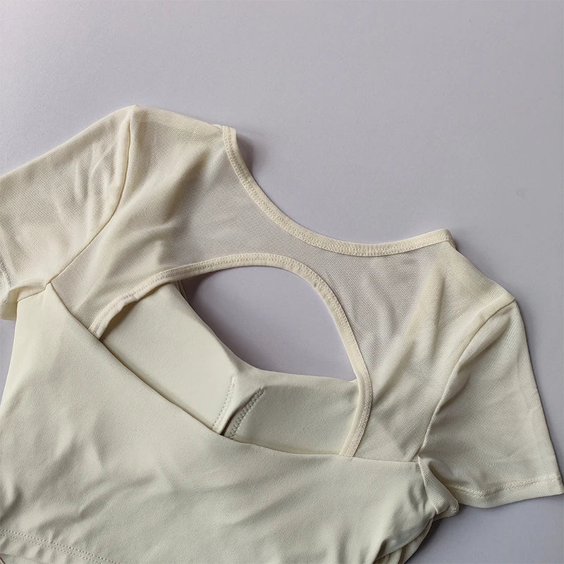 Light cream padded yoga shirts for women with a stylish open back design