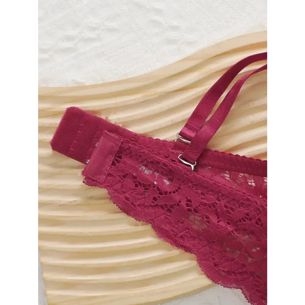 Close-up of part of a burgundy lace push up underwire bra and panty set with adjustable straps