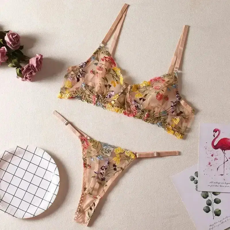 Floral embroidery lingerie set featuring delicate lace and vibrant floral patterns on a nude background