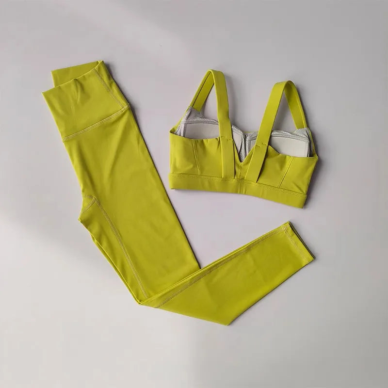 Bright yellow two piece workout clothing for women featuring a supportive sports bra and high-waisted leggings