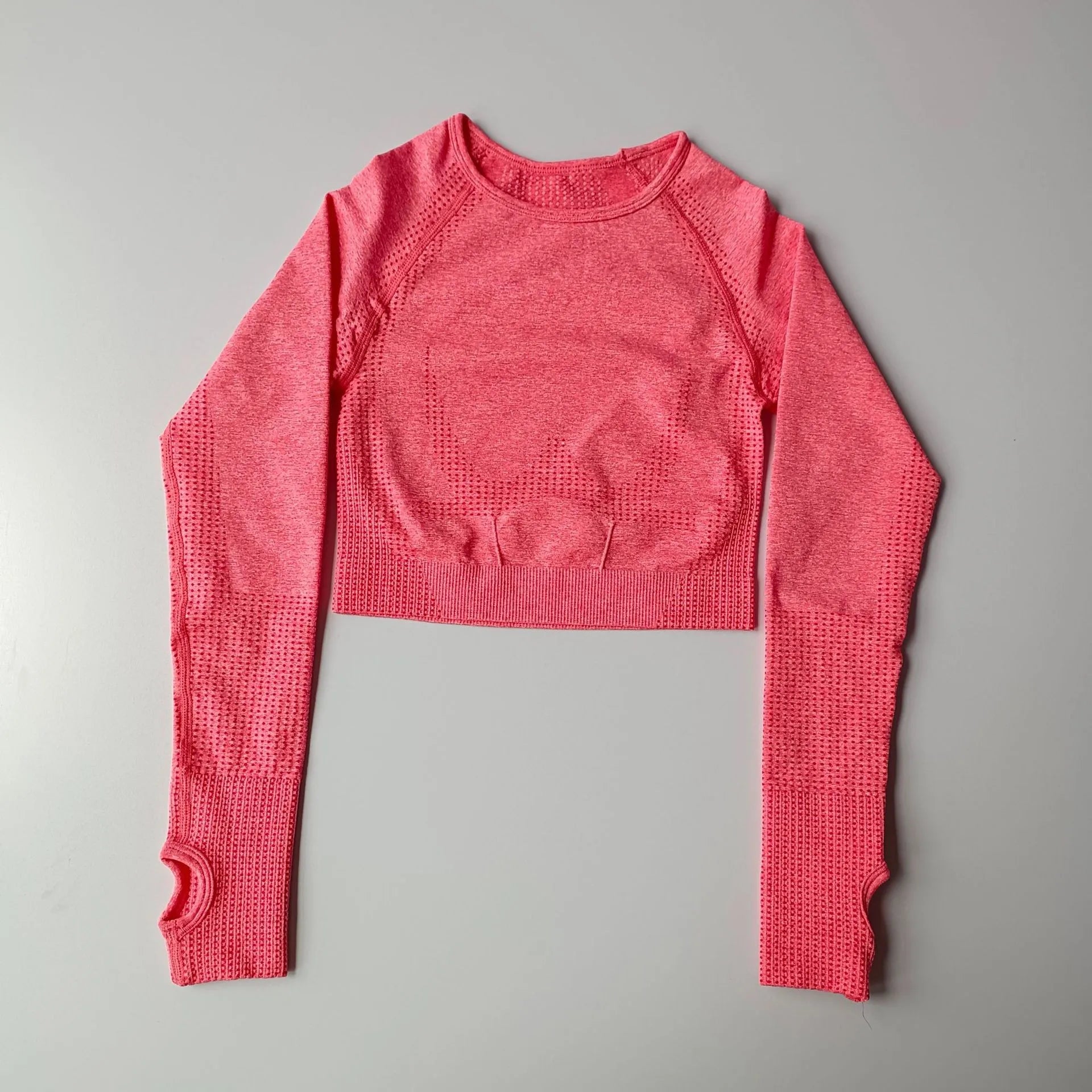 Pink long-sleeve crop top designed for comfort and style, ideal as yoga fitness tops for women
